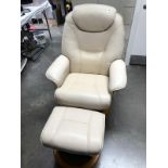A cream swivel armchair and matching stool
