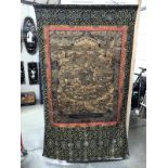 A silk tapestry wall hanging with oriental depictions