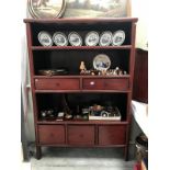 A redwood stained wall unit with drawers