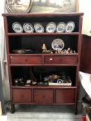 A redwood stained wall unit with drawers