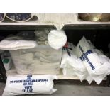 A large quantity of plain oven cloths and approximately 1800 disposable aprons