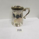 A silver presentation tankard.