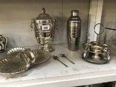 A silver plated entrée dish, ice bucket, egg cup stand and a cocktail shaker.