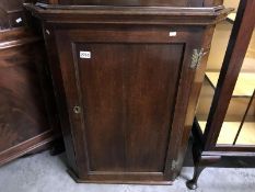 An oak corner cupboard