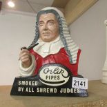 A Advertising figure for Orlive Pipes 'Smoked by All Shrewd Judges'.