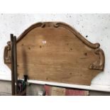 An antique pine single bed headboard