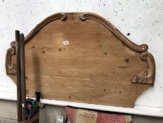 An antique pine single bed headboard