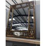 A large gilded ormolu framed bevel edge mirror