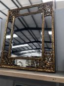 A large gilded ormolu framed bevel edge mirror