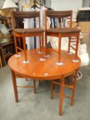 A 1970's teak extending dining table and 4 chairs