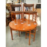 A 1970's teak extending dining table and 4 chairs