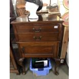 A 20th Century cabinet on cabriole legs featuring 2 drawers over 1 cupboard