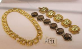 2 stone set bracelets and a yellow metal necklace.