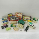 A mixed lot of die cast cars and caravans including some boxed.