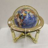A gem set table globe on brass base,