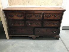 A 19th Century oak chest featuring lift up board with 3 faux drawers over 3 over 2 drawers