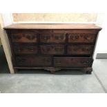 A 19th Century oak chest featuring lift up board with 3 faux drawers over 3 over 2 drawers