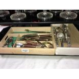 An ornate silver plated cutlery including berry spoons, tray of brass, wooden handle, cutlery etc.