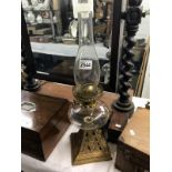 An oil lamp with metal stand,