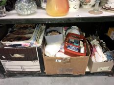 A shelf of sewing and knitting items including wool, cotton, patterns etc.