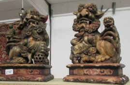 A pair of carved wood 19th century Dogs of Foo (some age cracks but otherwise good),