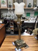 A brass table lamp with shade