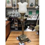 A brass table lamp with shade