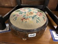 A Victorian footstool with tapestry top