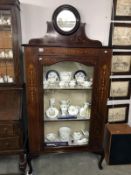 An Edwardian mahogany inlaid display cabinet with bevel edge circular mirror