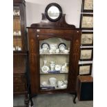 An Edwardian mahogany inlaid display cabinet with bevel edge circular mirror