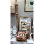 A collection of needlepoint items, stands, easels etc.