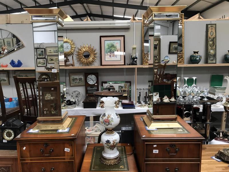 A pair of ornate gilded/mirrored torchiere stands