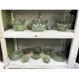 2 shelves of 1930's green glass posy bowls in plated metal frames