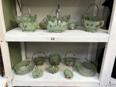 2 shelves of 1930's green glass posy bowls in plated metal frames