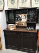 A 1930's oak dresser with leaded green bullseye top