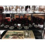 A large quantity of ruby and clear glass sundae dishes and drinking glasses