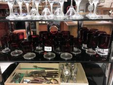 A large quantity of ruby and clear glass sundae dishes and drinking glasses