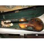 An old violin in wooden case (needs repair).