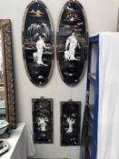 A pair of black lacquered oval plaques and a pair of black lacquered rectangular plaques depicting