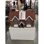A magnificent dolls house with real tiles and bricks plus a cabinet base with drawer and superb