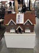 A magnificent dolls house with real tiles and bricks plus a cabinet base with drawer and superb