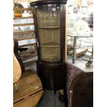 A mahogany corner display cabinet featuring painted signage 'Asprey London New Bond St Mayfair'