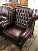 An oxblood wing back armchair