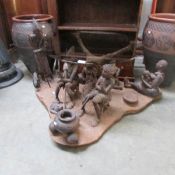 An unusual glass top table on a base depicting native scenes.