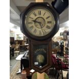 An American regulator wall clock by the New Haven Clock company with pendulum and key