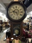 An American regulator wall clock by the New Haven Clock company with pendulum and key