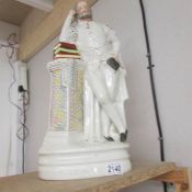 A large Victorian Staffordshire flat back figure of William Shakespeare leaning on a plinth,