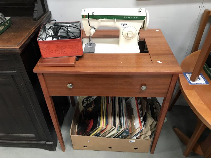 A Singer 247 sewing machine in table.