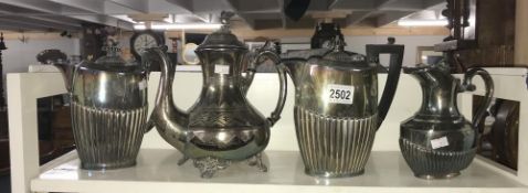 A 3 piece silverplate tea/coffee set and a silverplate coffee pot with eagle lid