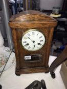 An oak case mantel clock with pendulum